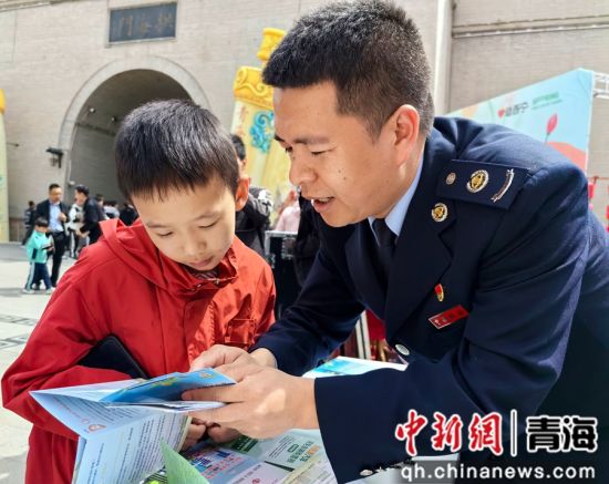 图为税务干部为小朋友讲解税收知识。 陈常蓉 摄 图为税务干部为小朋友讲解税收知识。 陈常蓉 摄