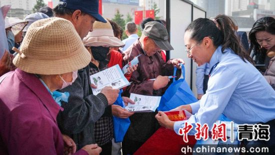 图为活动现场税务干部讲解税费优惠政策 杨扬 摄 图为活动现场税务干部讲解税费优惠政策 杨扬 摄