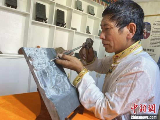 图为才旦加正在进行雕刻工作。受访者供图 图为才旦加正在进行雕刻工作。受访者供图